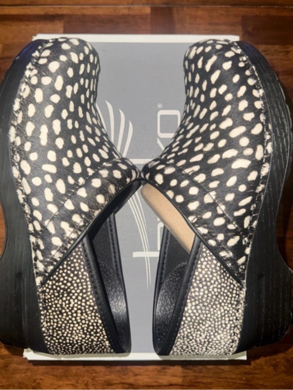 Dansko Black and White Spotted Slip-On Clogs